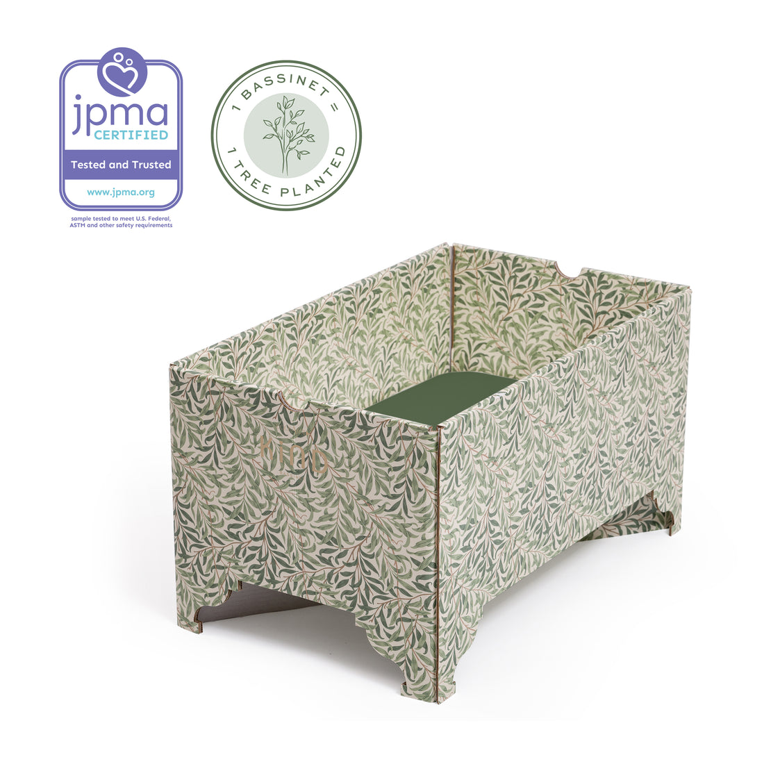 An image of a DockATot Kind Essential Bassinet - Willow Boughs, jpma certified, tree planted bassinet with a botanical print. The bassinet features ornately crafted pedestal feet and is designed for infant safety and comfort.